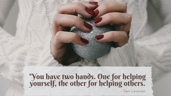 Close-up of a woman's hands holding a silver sphere, with the Sam Levenson quote: "You have two hands. One for helping yourself, one for helping others."